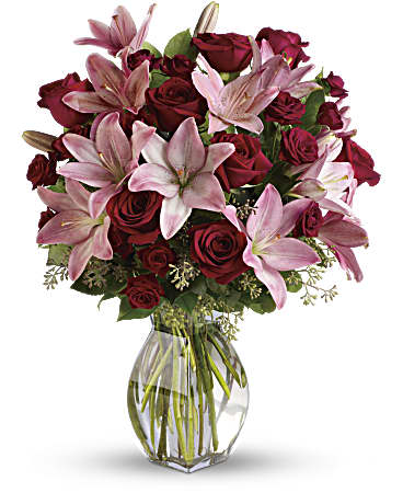 Lavish Love floral arrangement featuring pink lilies and red roses in a glass vase, symbolizing elegance and affection.
